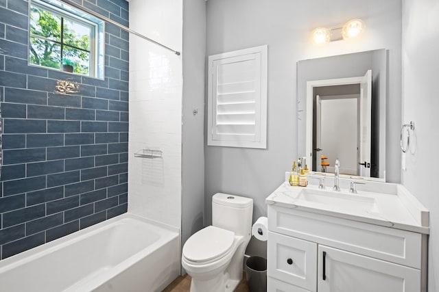 full bathroom featuring toilet, vanity, and tiled shower / bath combo