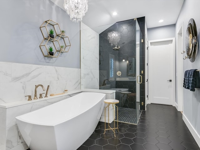 bathroom featuring tile patterned flooring, tile walls, and independent shower and bath