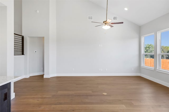 unfurnished living room featuring high vaulted ceiling, wood-type flooring, and ceiling fan