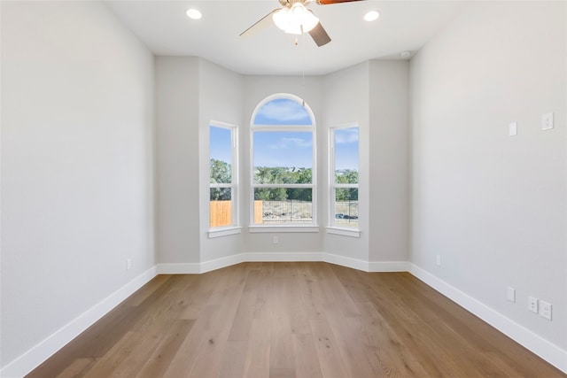 unfurnished room with hardwood / wood-style floors and ceiling fan