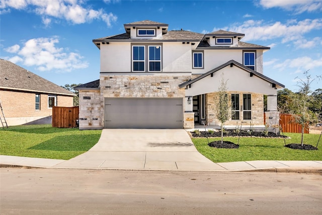 view of front of home featuring a garage and a front yard