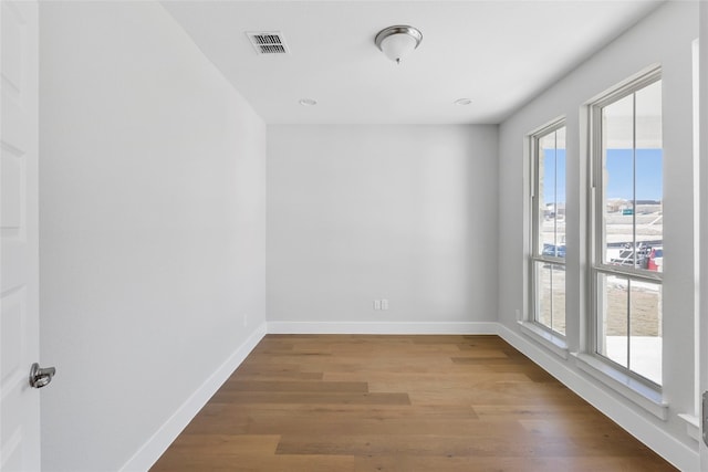 unfurnished room featuring hardwood / wood-style flooring