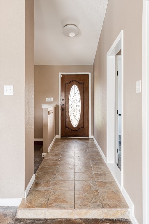 doorway to outside featuring light tile flooring