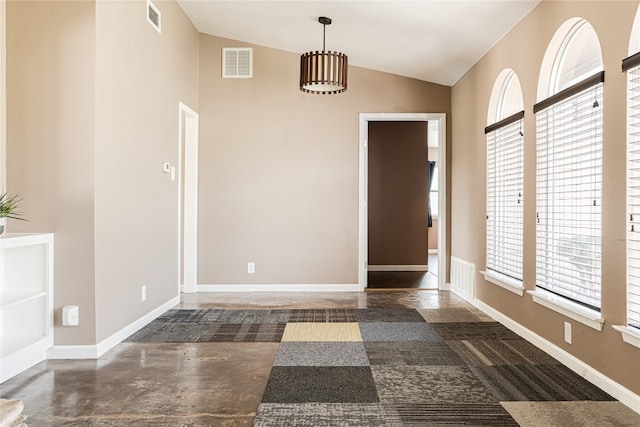 empty room featuring vaulted ceiling