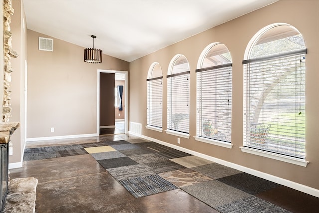 unfurnished room featuring lofted ceiling