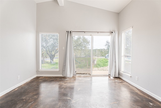 unfurnished room featuring beamed ceiling, high vaulted ceiling, and concrete floors