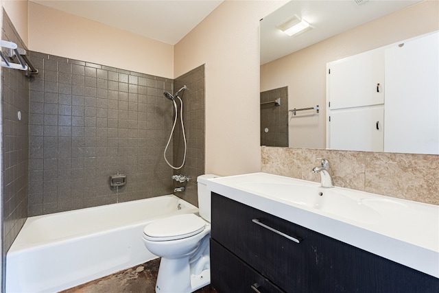 full bathroom featuring tiled shower / bath combo, vanity, and toilet