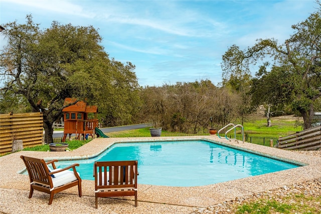 view of pool featuring a playground