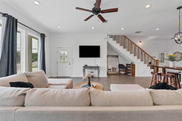 living room with dark wood-type flooring and ceiling fan