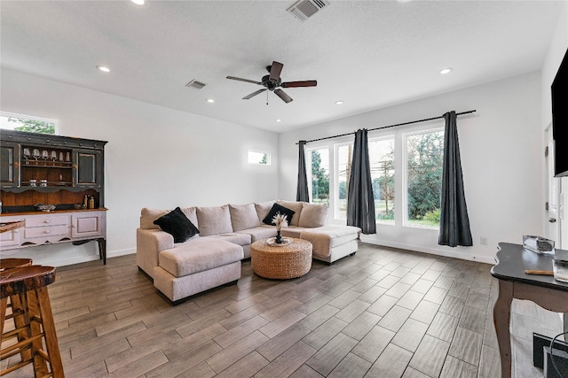 living room featuring ceiling fan and wood-type flooring