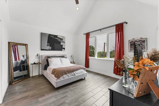 bedroom featuring high vaulted ceiling, ceiling fan, and hardwood / wood-style flooring