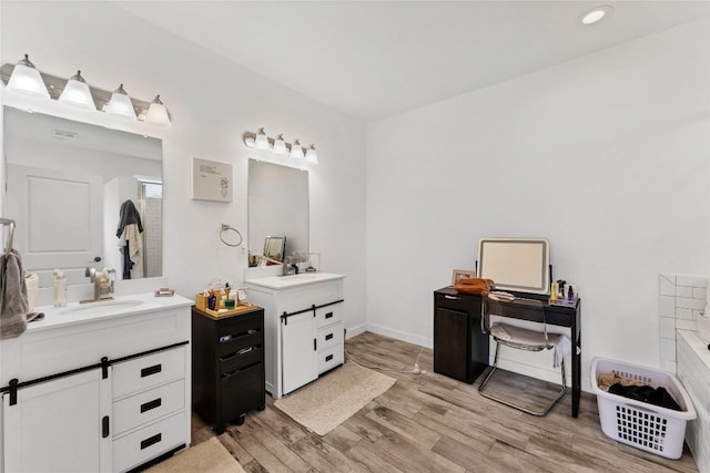 bathroom featuring dual vanity and wood-type flooring