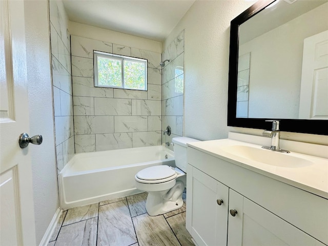 full bathroom with vanity, tiled shower / bath combo, and toilet