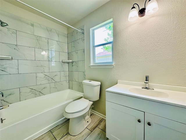 full bathroom with vanity, tiled shower / bath, and toilet