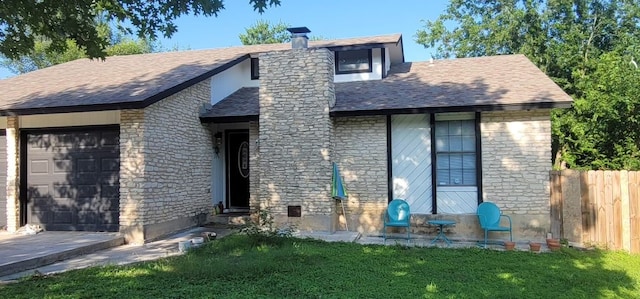 back of property with a garage and a yard