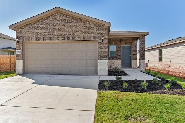 view of front of property featuring brick siding, fence, driveway, and an attached garage