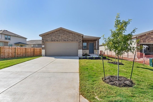 view of front of property featuring brick siding, an attached garage, fence, driveway, and a front lawn