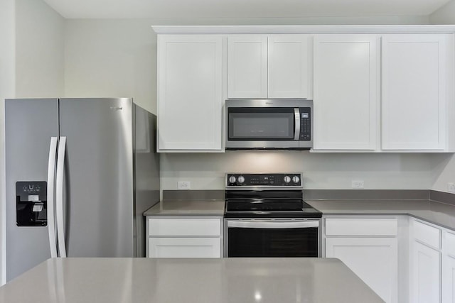 kitchen with stainless steel appliances and white cabinetry