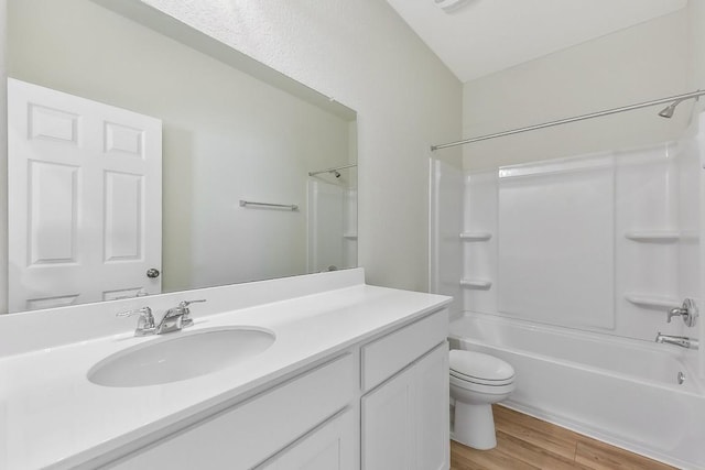 full bathroom featuring vanity, shower / bathing tub combination, wood finished floors, and toilet