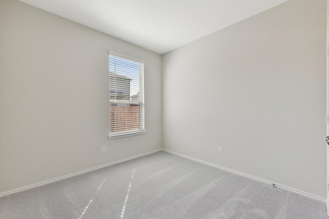 empty room with carpet floors and baseboards