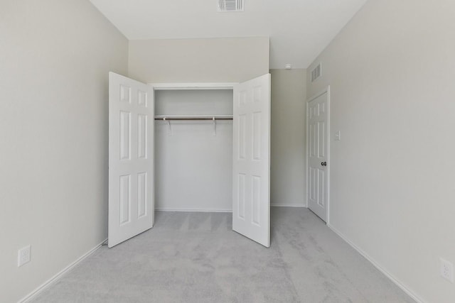 unfurnished bedroom with carpet, visible vents, and baseboards