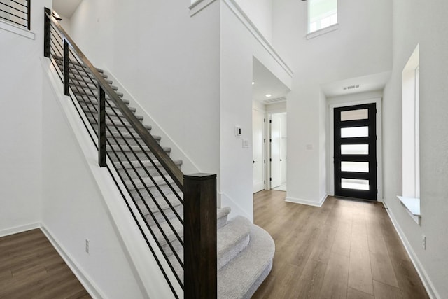 foyer featuring a high ceiling and hardwood / wood-style floors