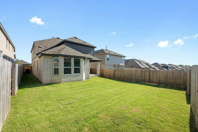 rear view of property featuring a yard