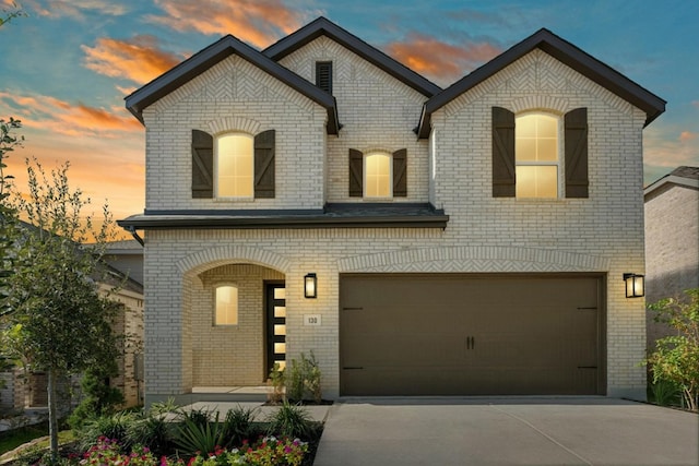 french provincial home with a garage