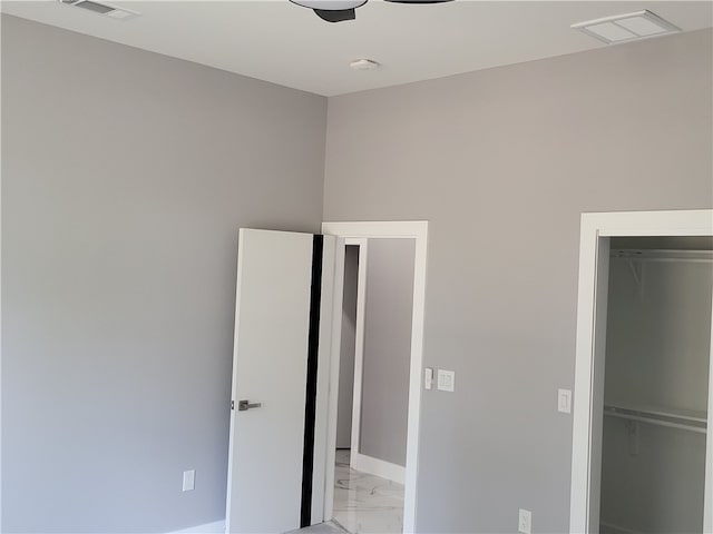 unfurnished bedroom with a closet, ceiling fan, and light tile floors