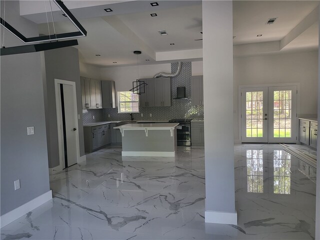 kitchen with light tile floors, french doors, gray cabinetry, and a center island