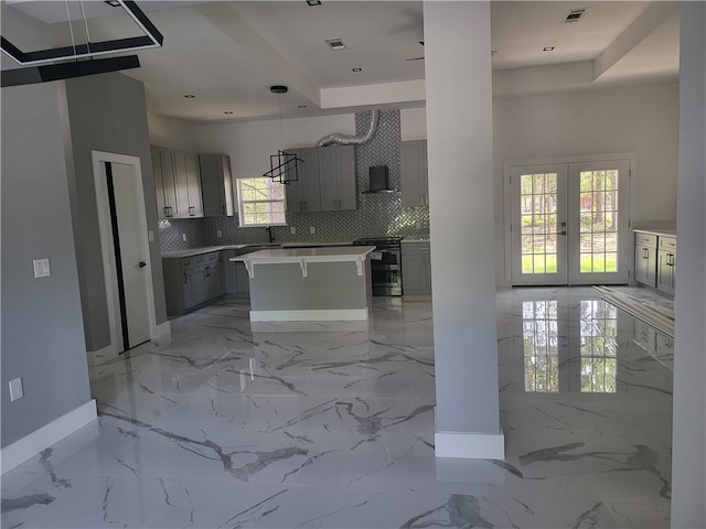 kitchen with a center island, french doors, gray cabinets, tasteful backsplash, and light tile floors