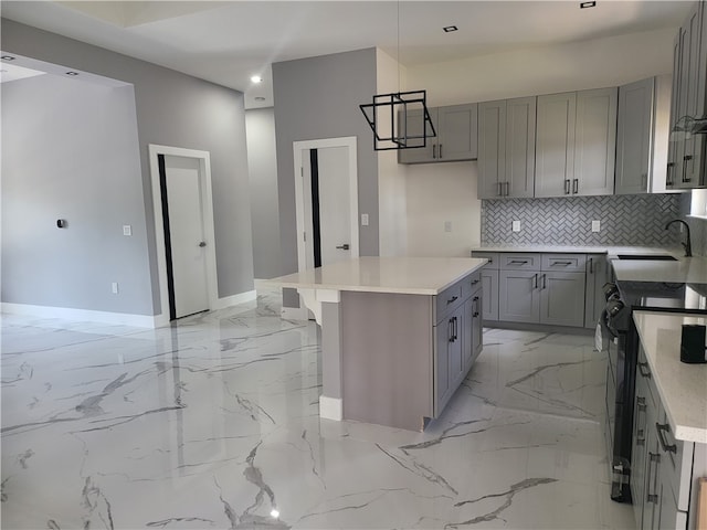 kitchen with a kitchen island, electric range, sink, tasteful backsplash, and light tile flooring