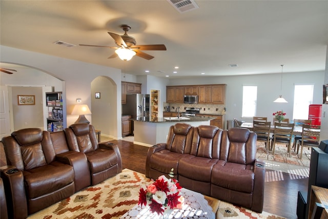 living room featuring light hardwood / wood-style floors, sink, and ceiling fan