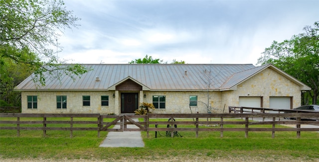 ranch-style house with a garage and a front lawn