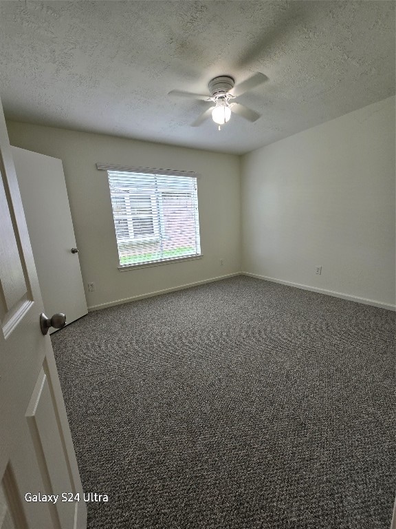 carpeted empty room featuring a textured ceiling and ceiling fan