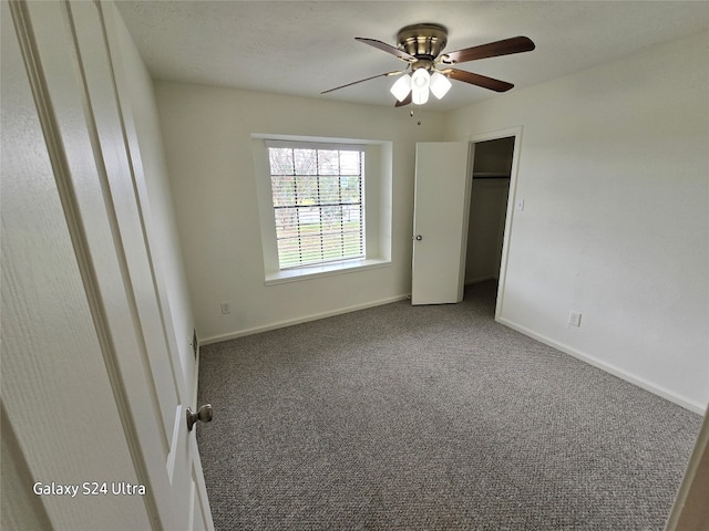 unfurnished bedroom featuring a closet, ceiling fan, and carpet floors