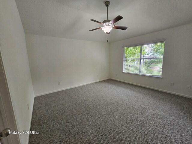 spare room with ceiling fan, carpet floors, and vaulted ceiling