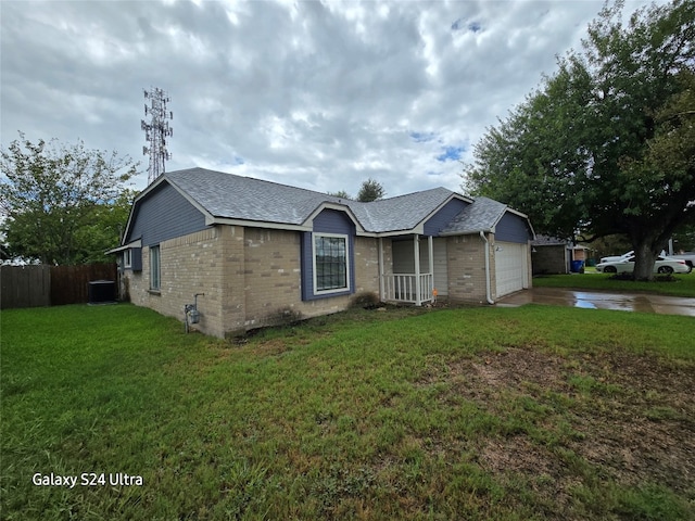 ranch-style house with a garage, a front yard, and cooling unit