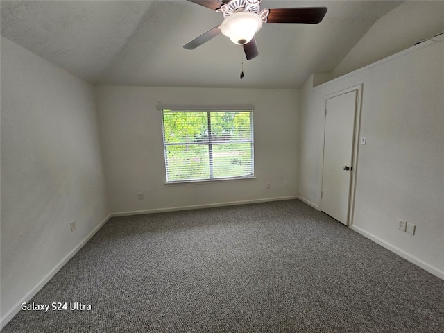 spare room with lofted ceiling, ceiling fan, and carpet floors