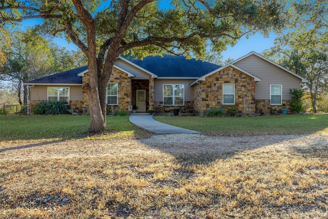 single story home featuring a front lawn