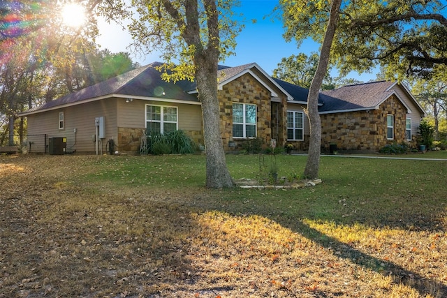 ranch-style house with a front lawn and central AC unit