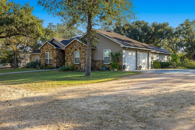 ranch-style home with a front yard and a garage