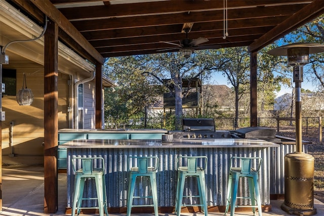 view of patio / terrace featuring a bar and ceiling fan