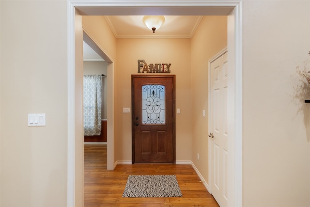 entryway featuring hardwood / wood-style flooring and ornamental molding