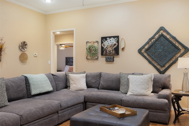 living room featuring ornamental molding, hardwood / wood-style floors, and ceiling fan