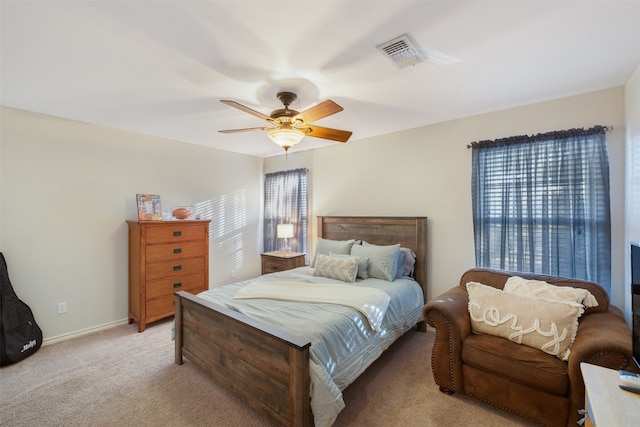 carpeted bedroom with multiple windows and ceiling fan