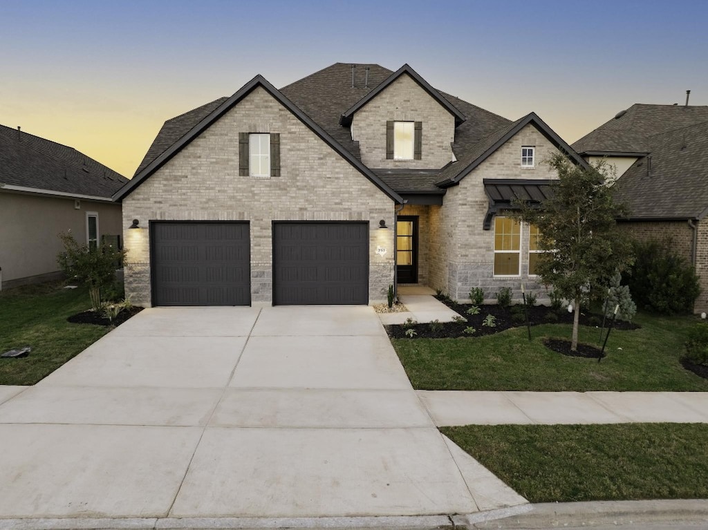 french country home with a garage and a yard