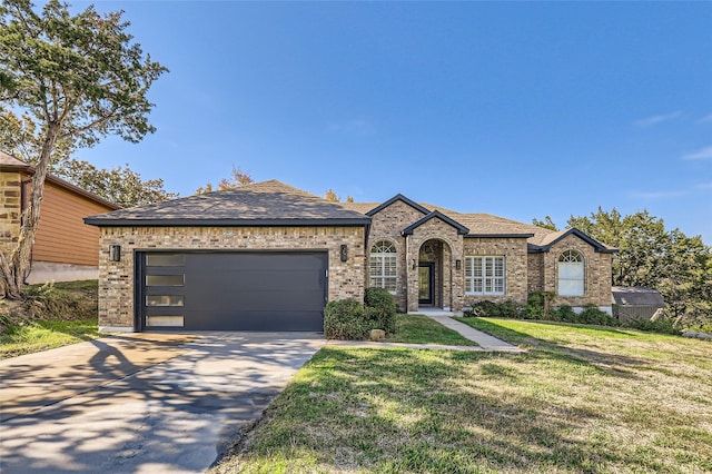 view of front facade featuring a garage and a front lawn