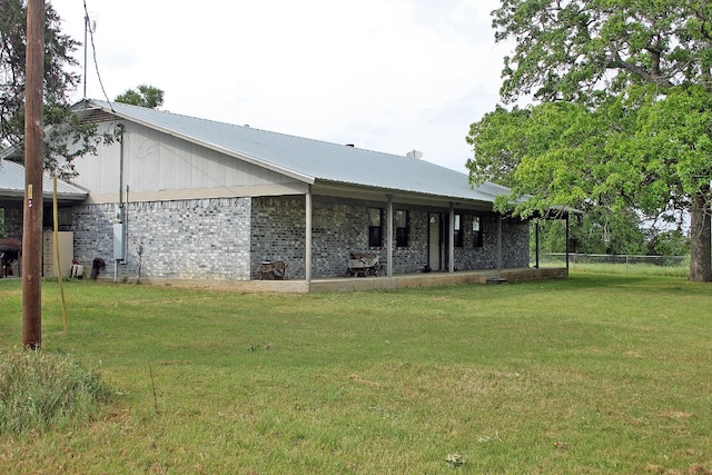 rear view of house with a lawn