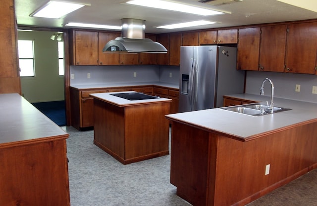 kitchen with island exhaust hood, light carpet, sink, and stainless steel fridge